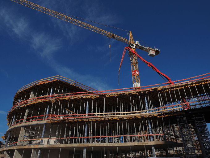 A crane on top of a building being constructed